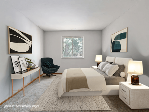A modern bedroom with a large bed, a chair, and window