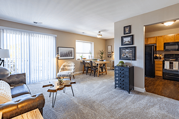 the view of a living room with a dining room and a kitchen