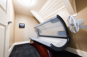 a spa room with a chair and a fan