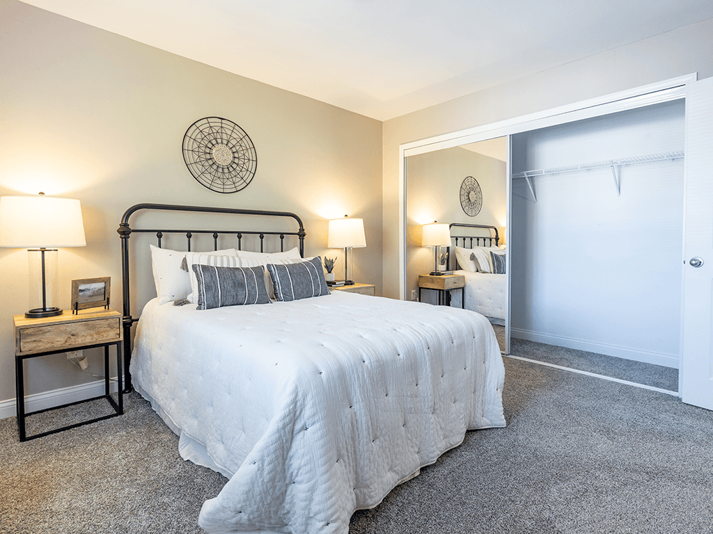 a bedroom with a bed and a closet