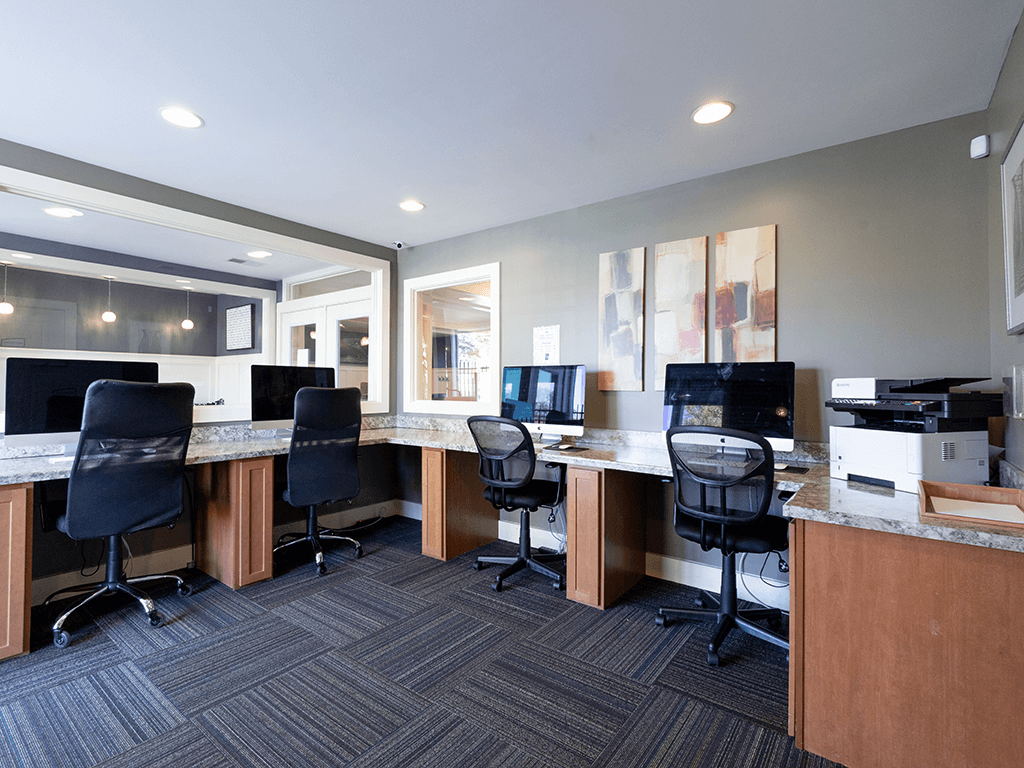 an office with desks and computers and chairs