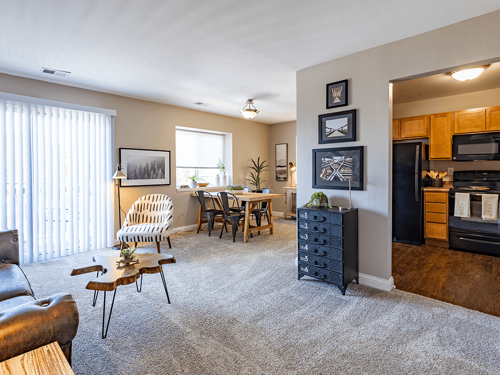 the view of a living room with a dining room and a kitchen