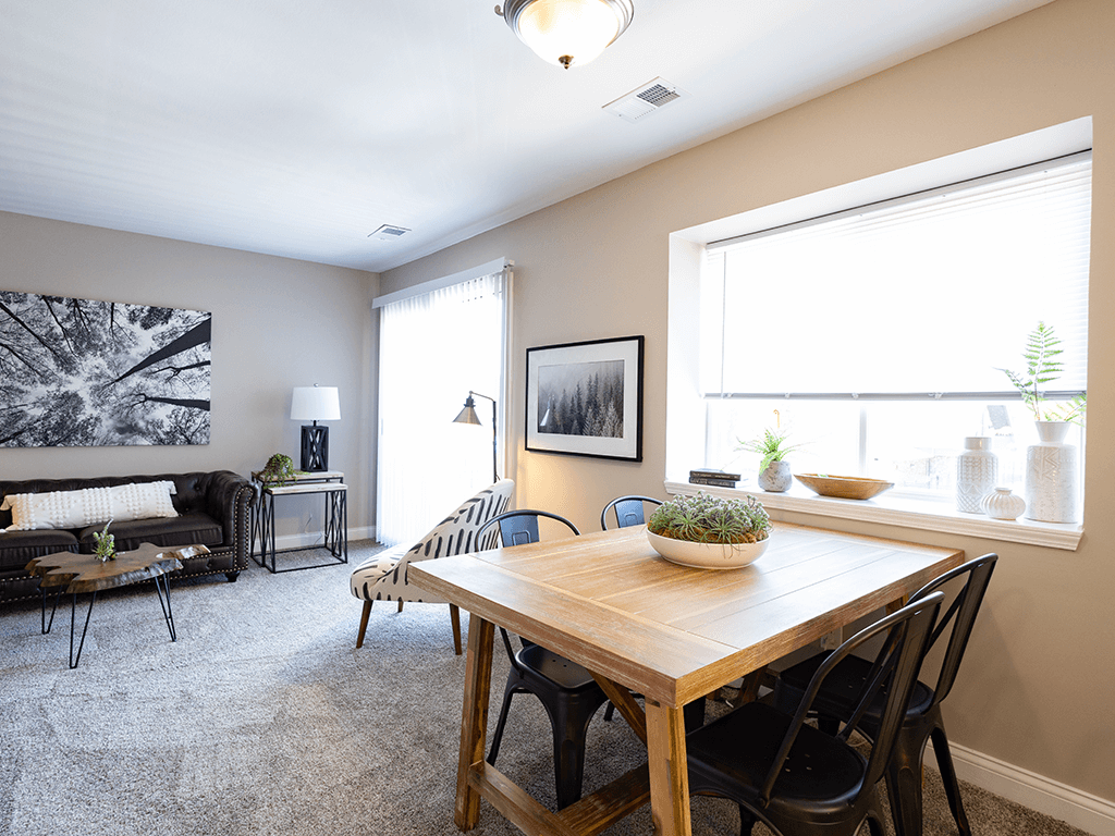 a dining room with a wooden table and chairs