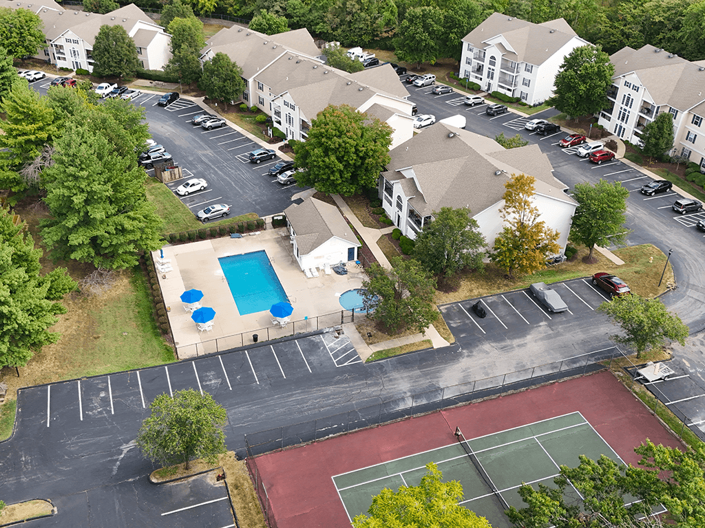 view of apartment buildings with off street parking