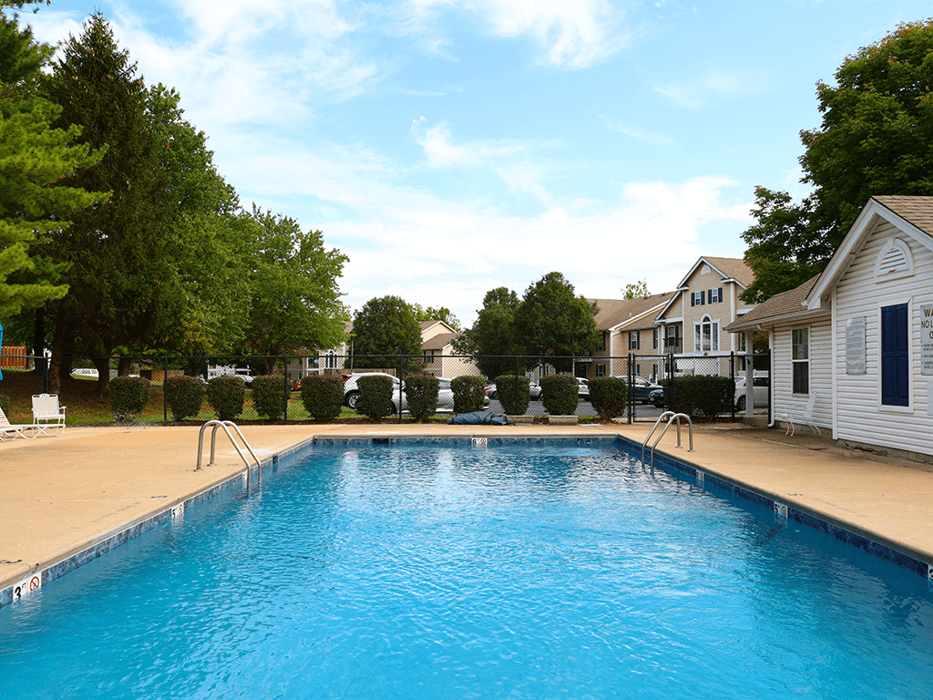 swimming pool with apartments in the background