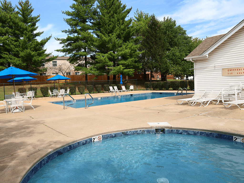 resident swimming pool with chairs and umbrellas