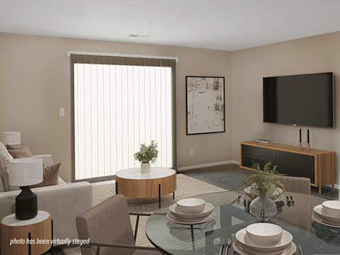 A living room with a glass table and a television on the wall.
