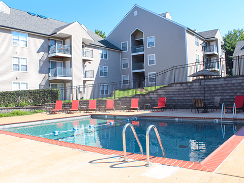 A swimming pool in front of apartment buildings.