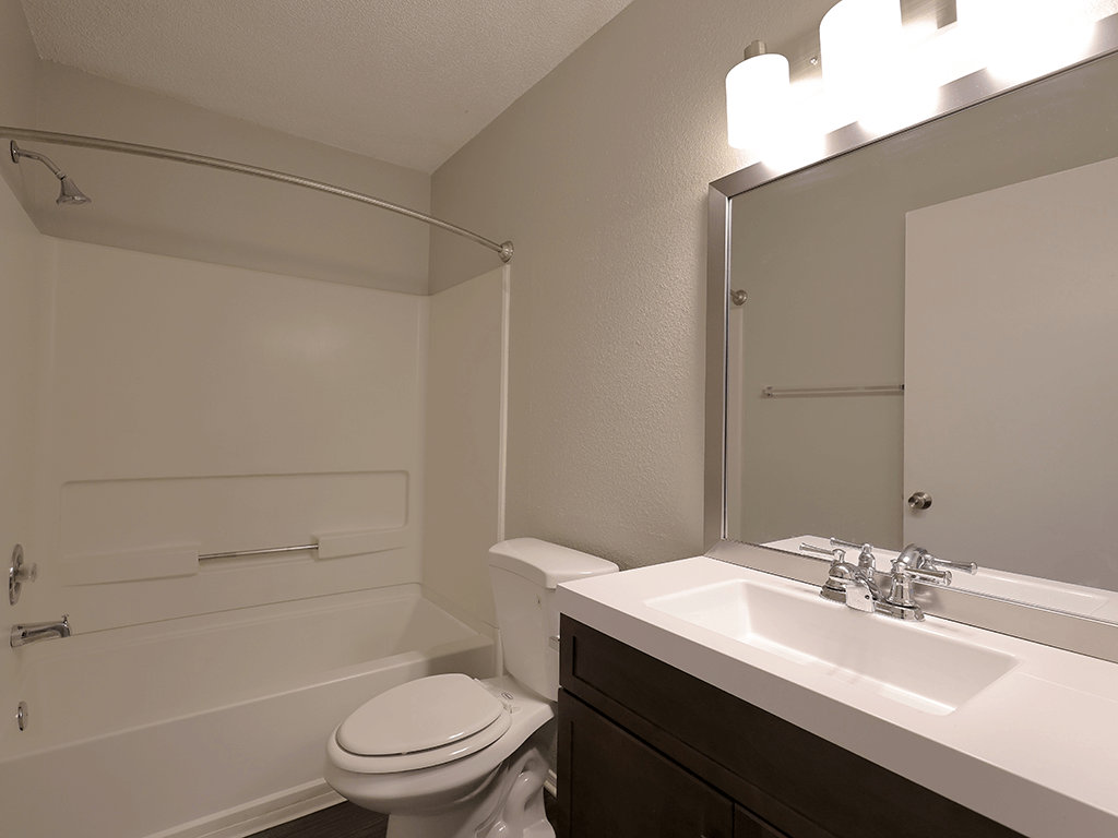 a bathroom with a sink toilet and a mirror