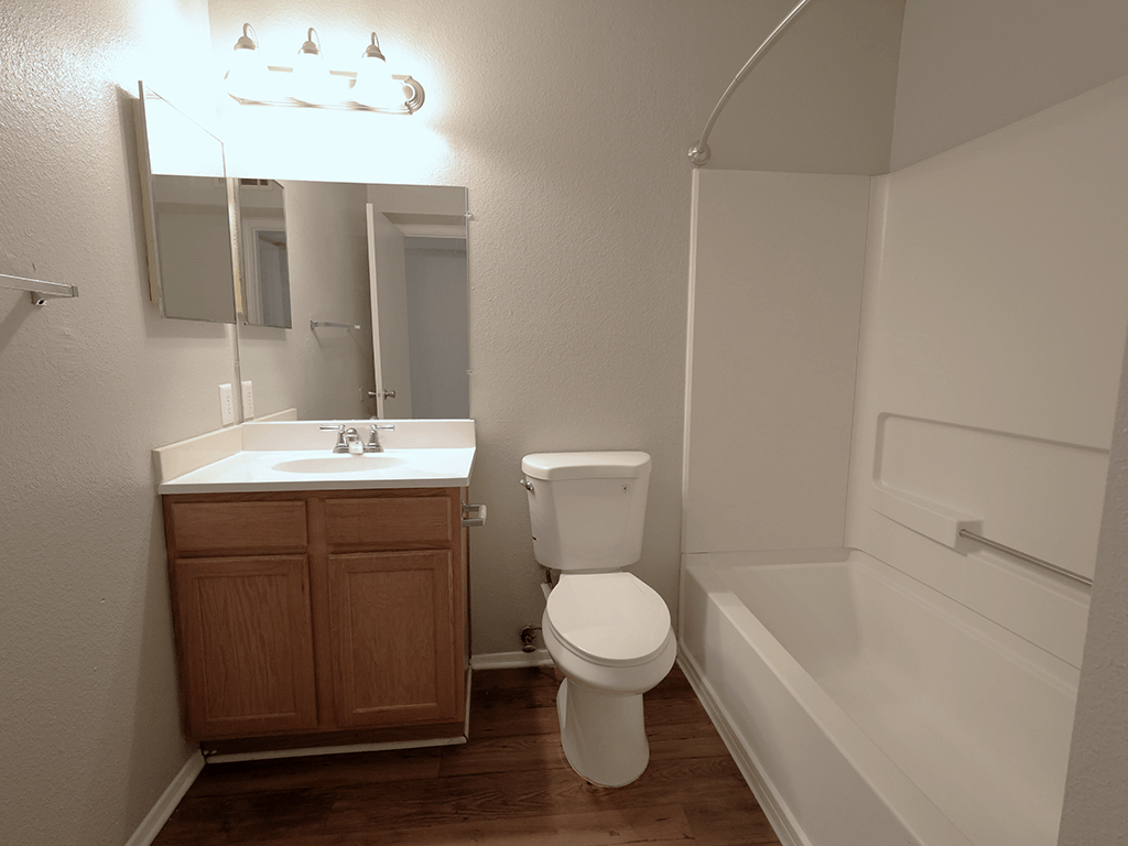 an empty bathroom with a toilet sink and bath tub