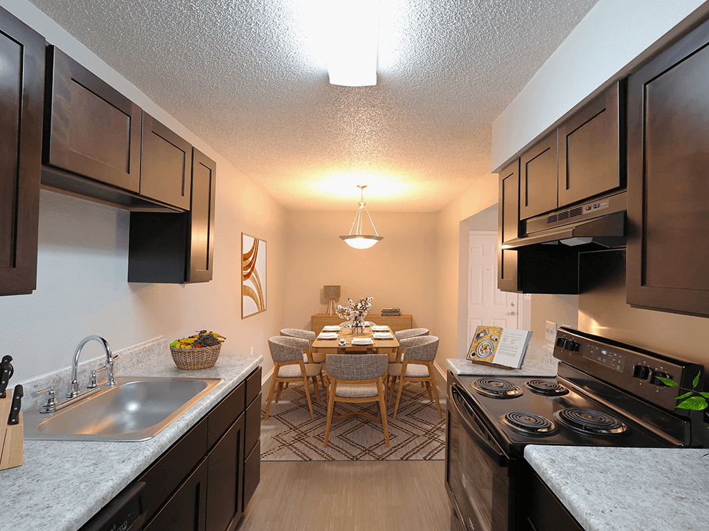 full kitchen and dining room with stainless steel appliances and wood flooring