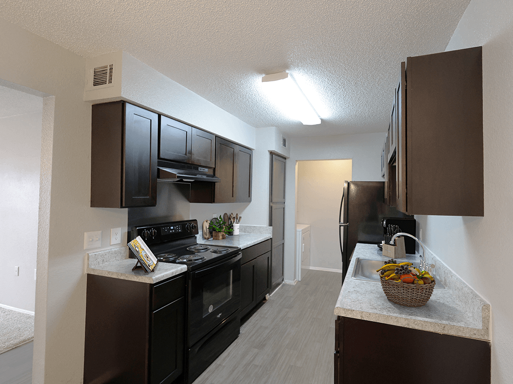 our apartments have a modern kitchen with black appliances and granite counter tops