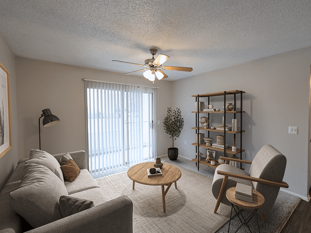 an open living room with a ceiling fan and a window
