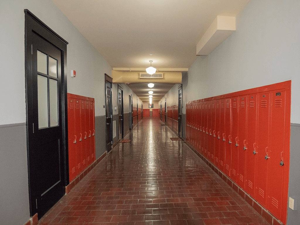 Former high school hallway with red lockers