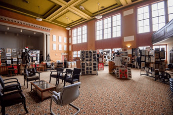 A large room with a lot of furniture and a patterned carpet.