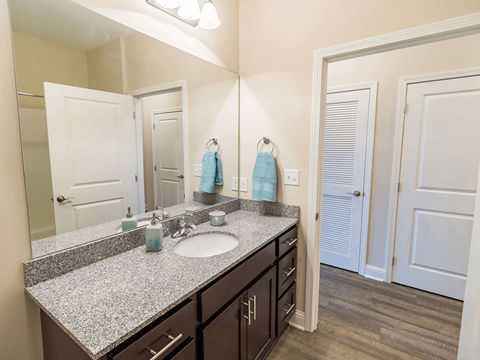 apartment bathroom with a sink and mirror