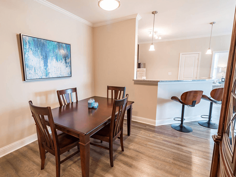 A dining room with a table and chairs