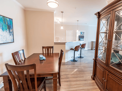 A dining room with a wooden table and chairs.