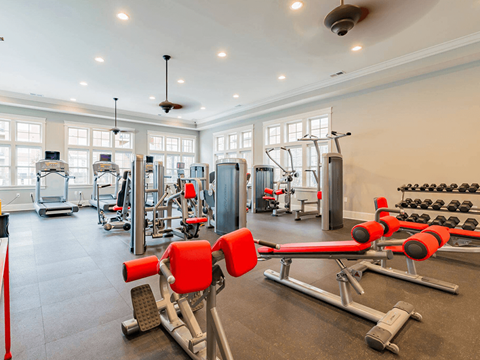 A gym with a variety of equipment including weights and machines.