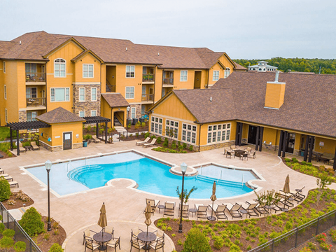 A large building with a pool in front.