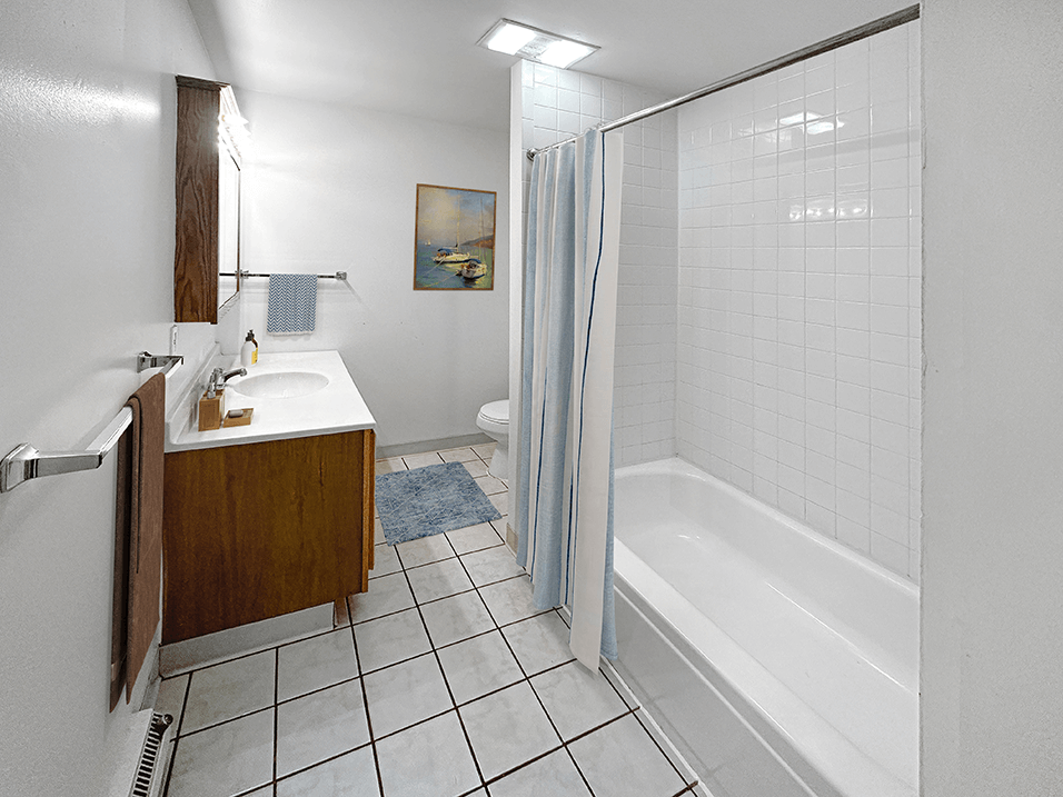a bathroom with a white tub and a white sink