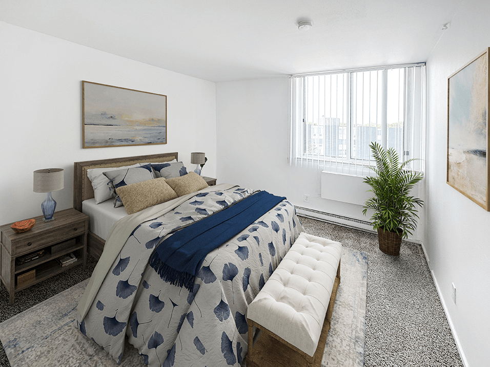 a bedroom with white walls and a large bed with a blue and white comforter