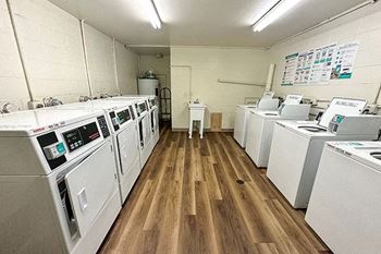 a room with a bunch of washing machines in it