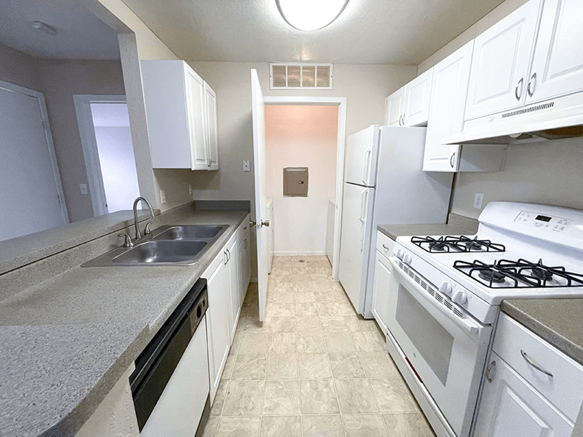 a kitchen with white cabinets and white appliances