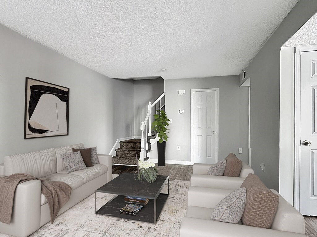 a living room with white couches and a coffee table