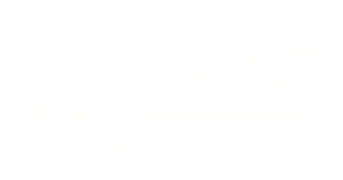 The Wyatt at Northern Lights logo on a green background.