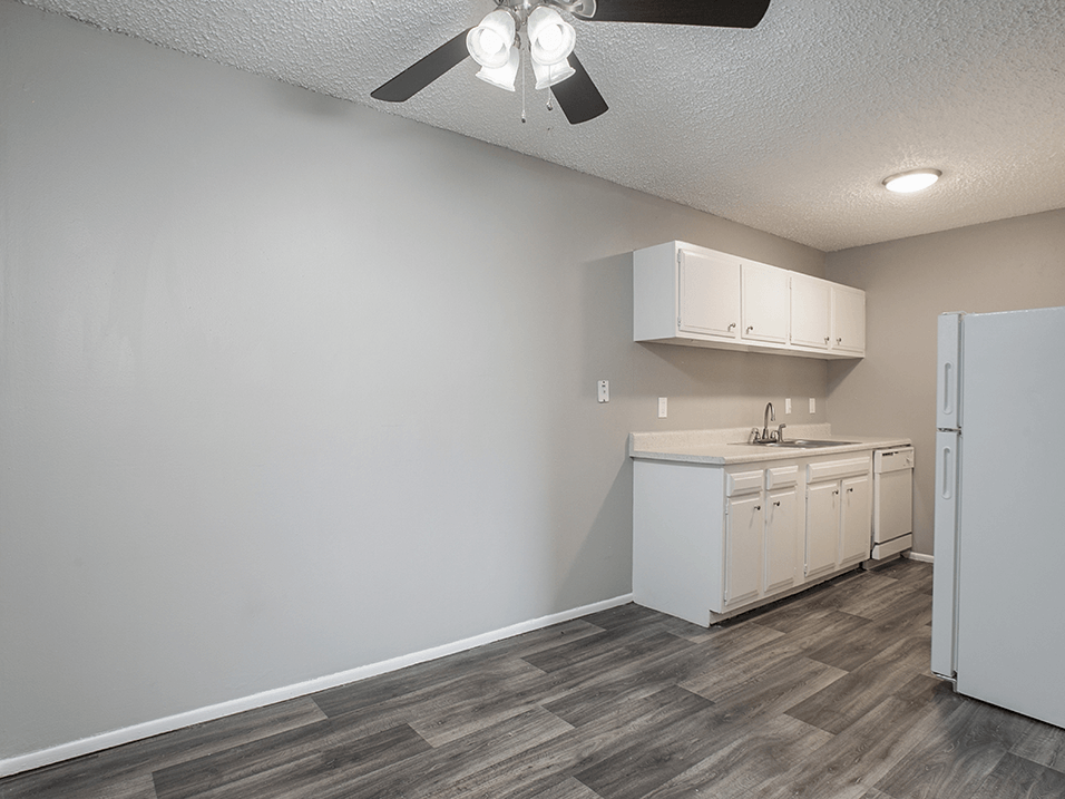 kitchen with white cabinets and wood style flooring in wichita ks