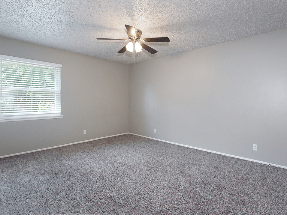 large livinging room with window and ceiling fan at westborough arms apartments