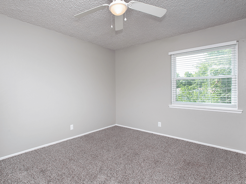 bedroom with large window in wichita apartment