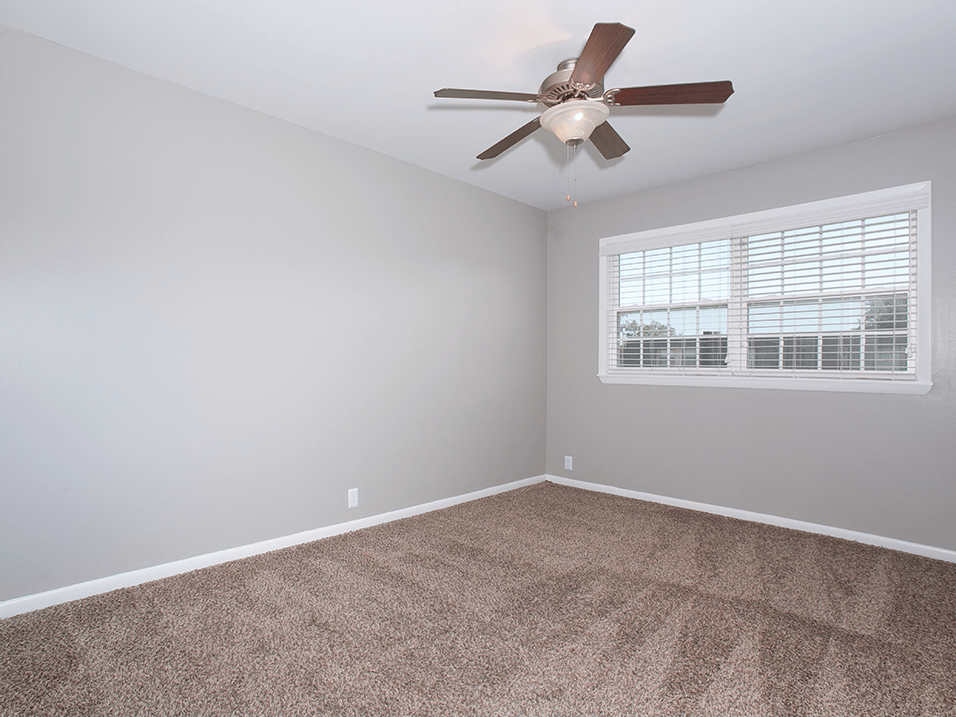 bedroom with overhead fan and light at westborough arms apartments