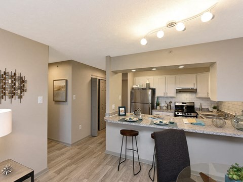 a kitchen with a bar and a counter top in a living room