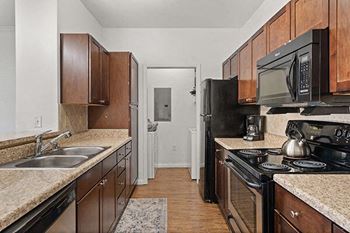 a kitchen with a stove microwave and sink