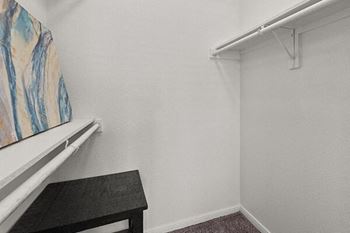 a white room with a black table and a white closet