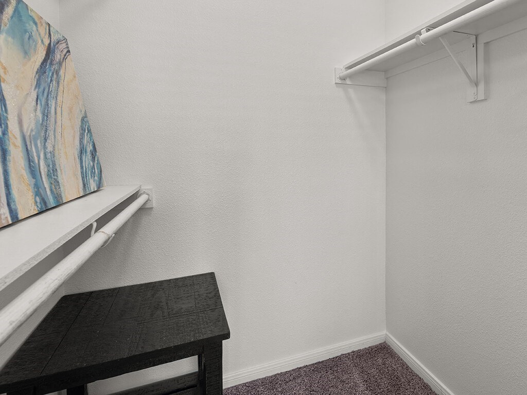 A small room with a table and a painting on the wall.