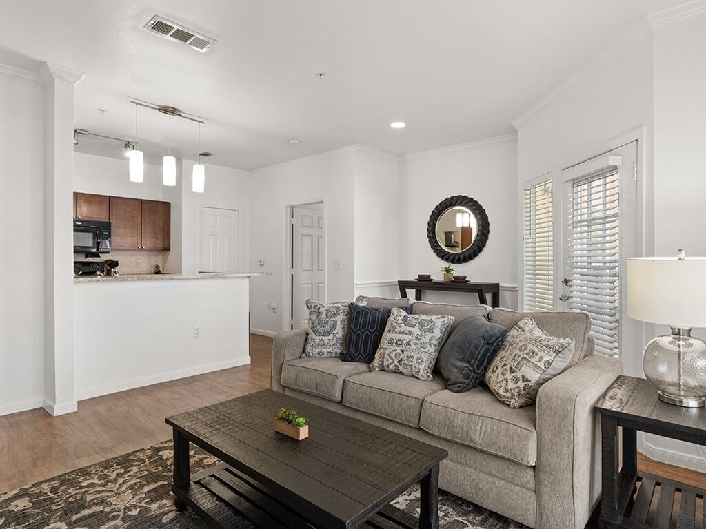A living room with a grey couch and a coffee table.