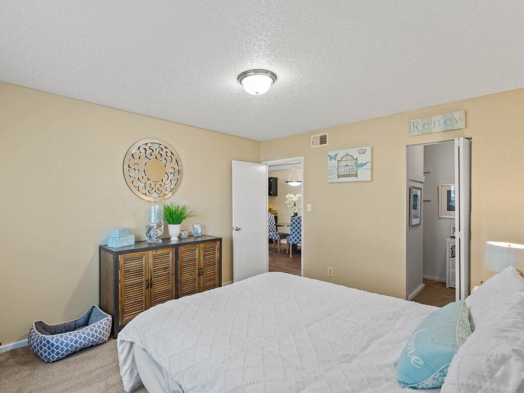 a bedroom with a bed and a dresser