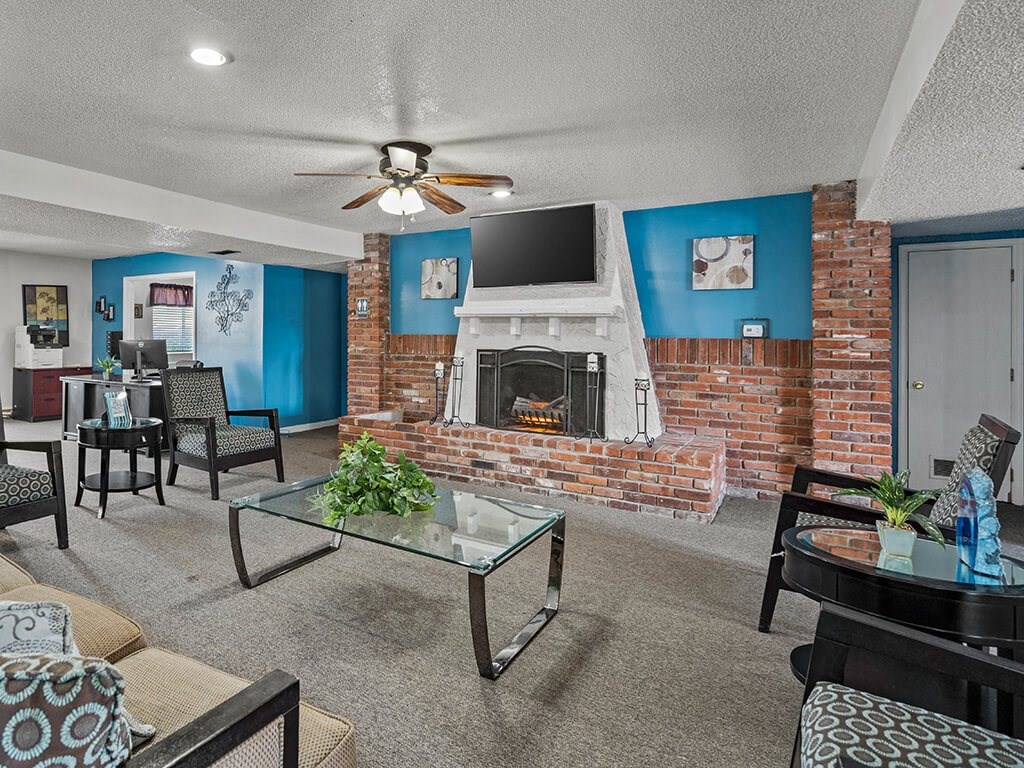 a living room with a brick fireplace and a television