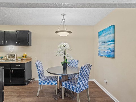 a dining room with a table and chairs and a kitchen