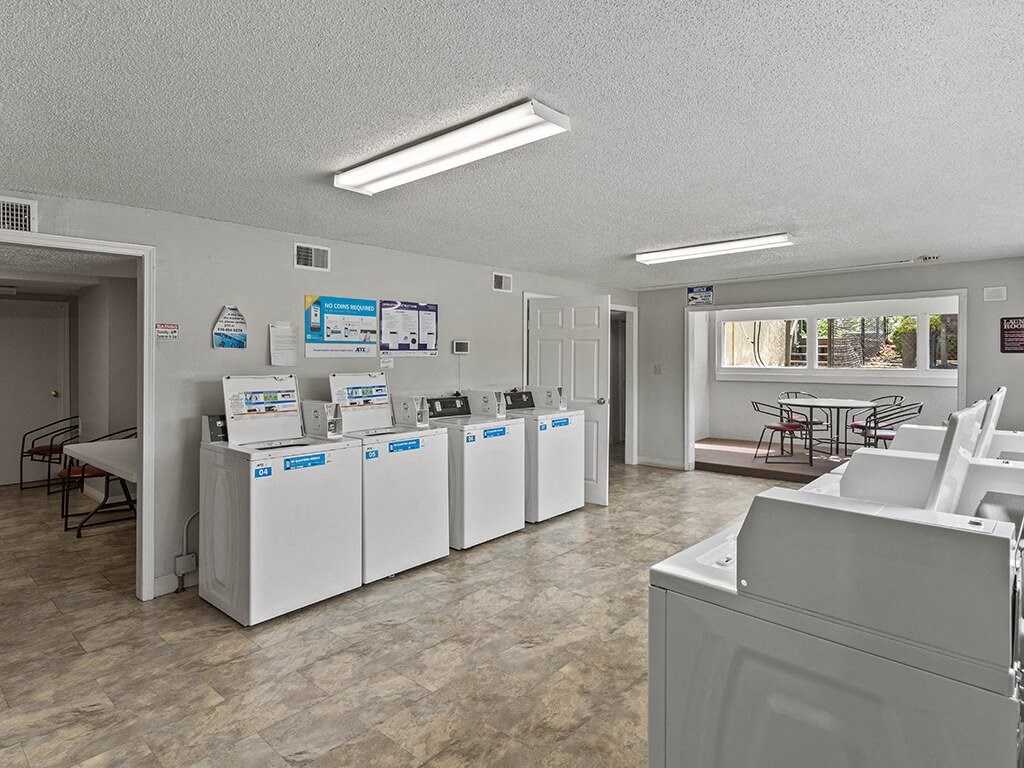 a group of washers and dryers in a room