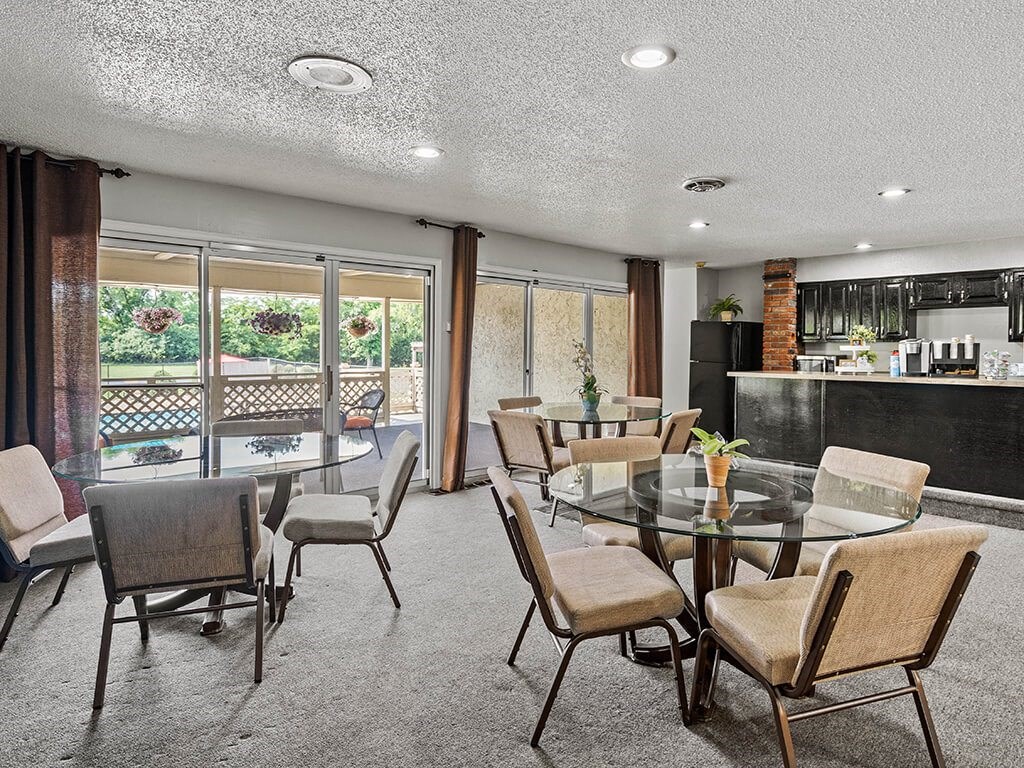 a dining room with a glass table and chairs