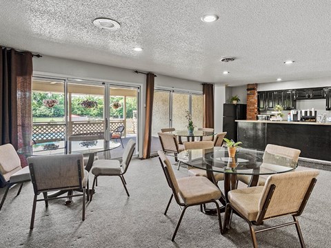 a dining room with a glass table and chairs