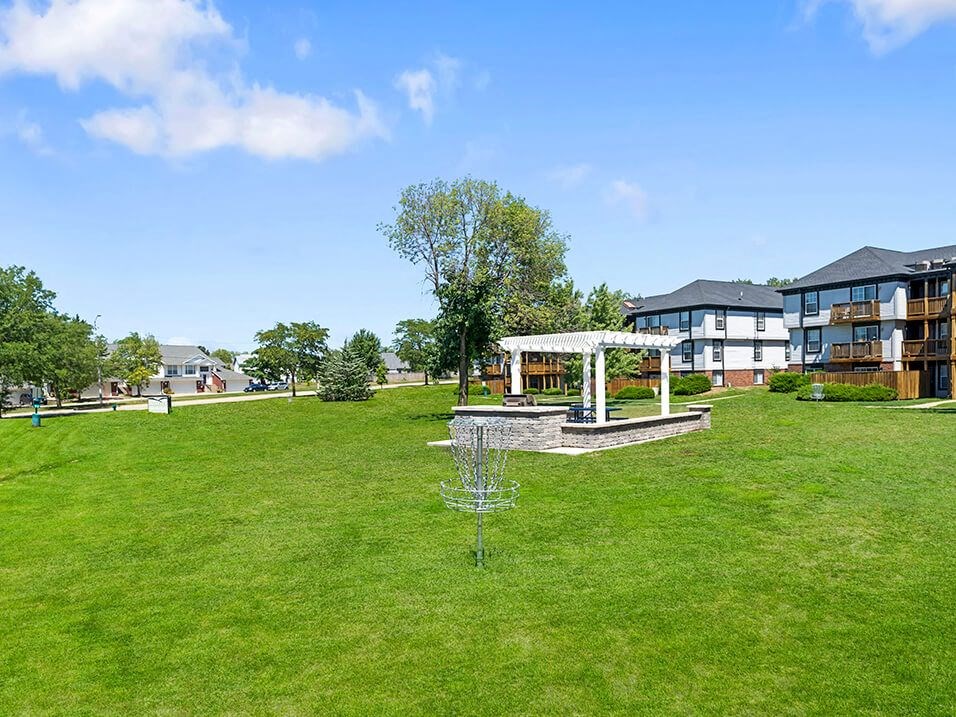 a large grassy area with a gazebo at apartment complex