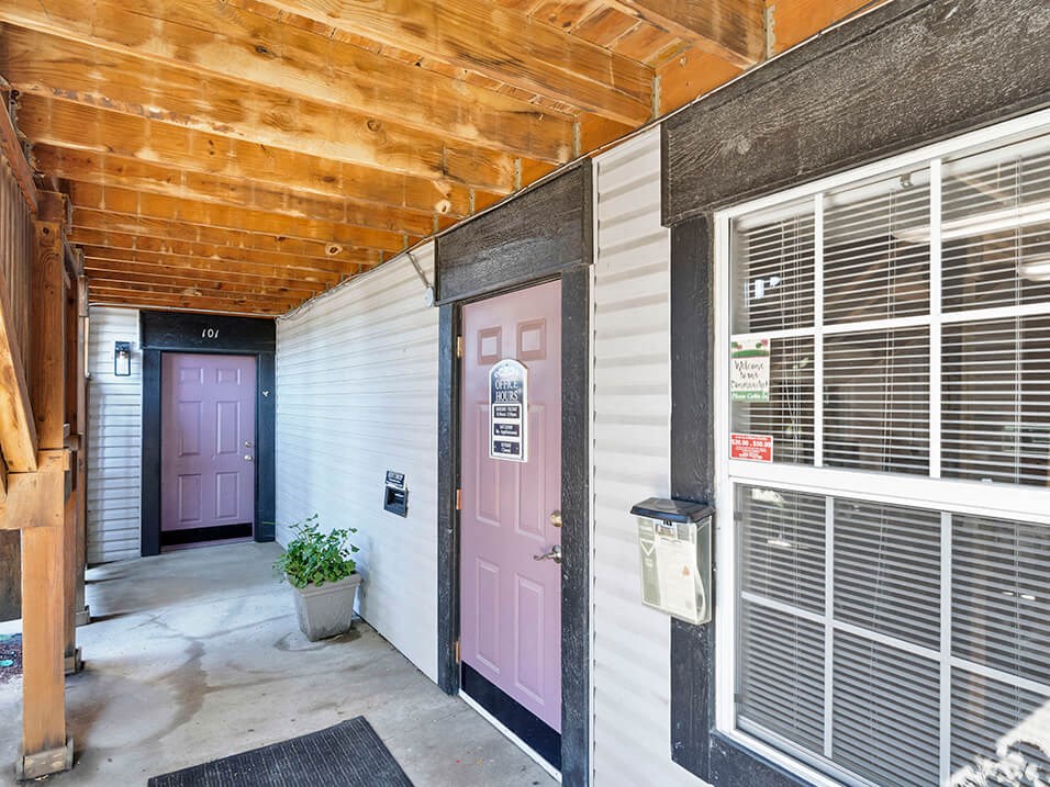 a door at the entrance to the leasing office with a wooden ceiling