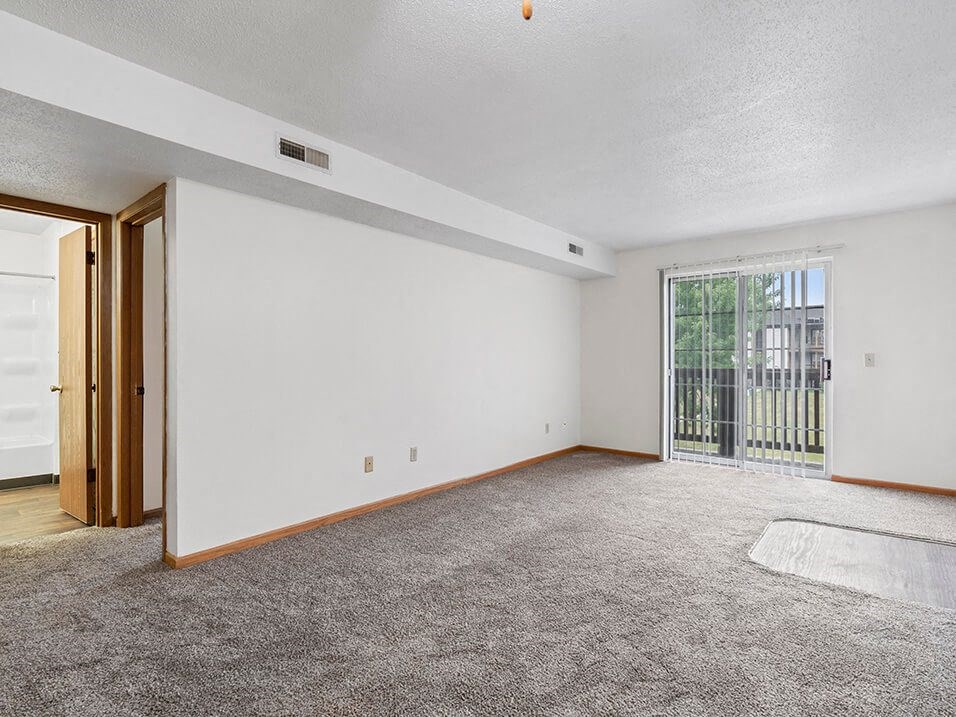 apartment living room with a sliding glass door to a balcony