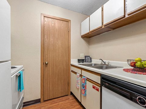 a kitchen with a sink and a refrigerator