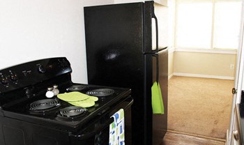 all black appliance kitchen at Palo Duro Place apartments - Photo Gallery 4